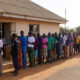 African citizens voting in an election, highlighting the democracy trap where ballots exist but real political and economic power remains limited.