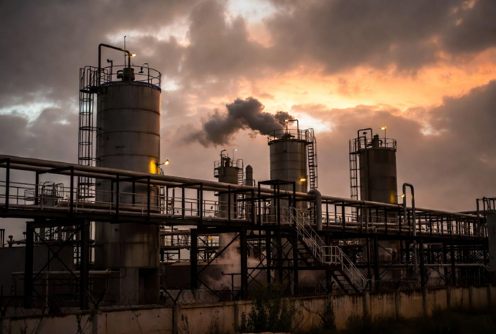 An industrial processing facility at dusk, symbolizing the need for reliable and stable energy to power Africa's manufacturing sector and agro-industrial clusters.
