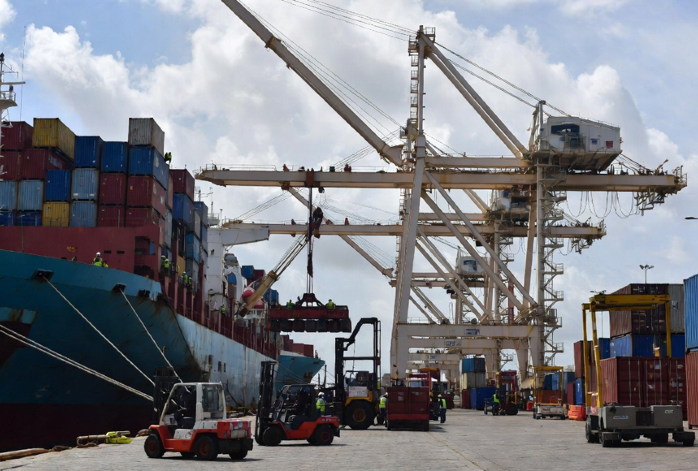 Tunisian port workers loading export cargo ships bound for European Union markets under Euro-Mediterranean trade agreements