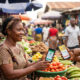 African market vendor accepting mobile money payment demonstrating financial inclusion