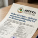 Close-up of trade document with AfCFTA logo and text "Rules of Origin – defining economic nationality for African goods.