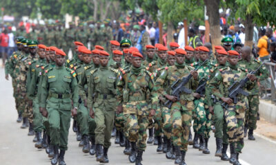 Chadian military troops march in formation during a deployment ceremony, representing Chad's 1,500-strong contingent committed to Haiti's Gang Suppression Force