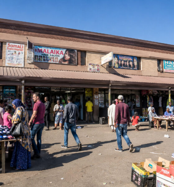 South African township street market with African migrant traders and vendors