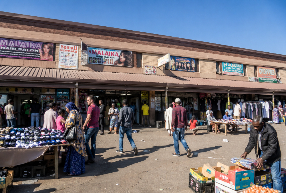 South African township street market with African migrant traders and vendors