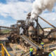 Southern Africa mining and processing facility with workers refining lithium and copper, symbolizing the region’s shift from raw mineral exports to local beneficiation, industrialization, renewable energy integration, and modern transport corridors.