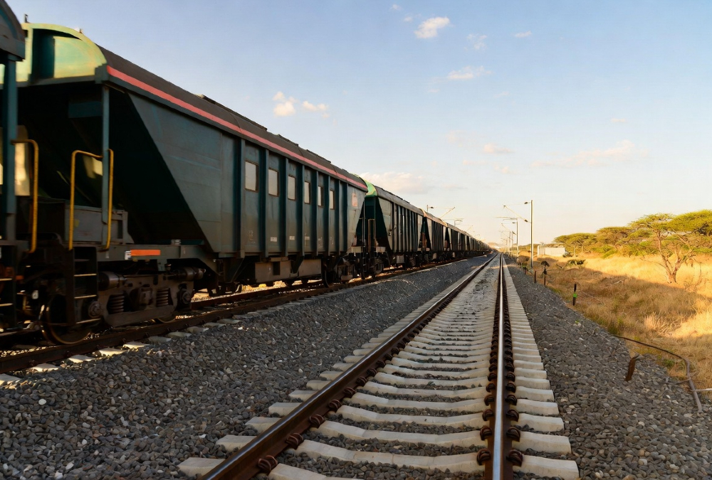 Freight train on East Africa's new standard gauge railway corridor, symbolizing integrated trade infrastructure and customs harmonization for seamless regional commerce.