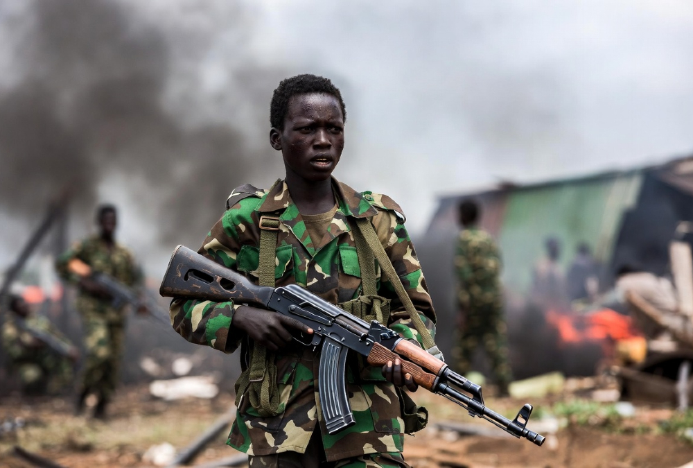 Child soldier in eastern DR Congo armed conflict, highlighting the ongoing child recruitment crisis in Central Africa.
