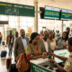 African travelers passing through an airport border checkpoint, representing the easing of visa restrictions and the push toward continental mobility under AfCFTA.