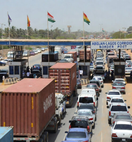 Vehicles on the Abidjan-Lagos corridor waiting at a border checkpoint, illustrating Africa corridor governance challenges and the need for shared ownership and logistics performance metrics.