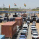 Vehicles on the Abidjan-Lagos corridor waiting at a border checkpoint, illustrating Africa corridor governance challenges and the need for shared ownership and logistics performance metrics.