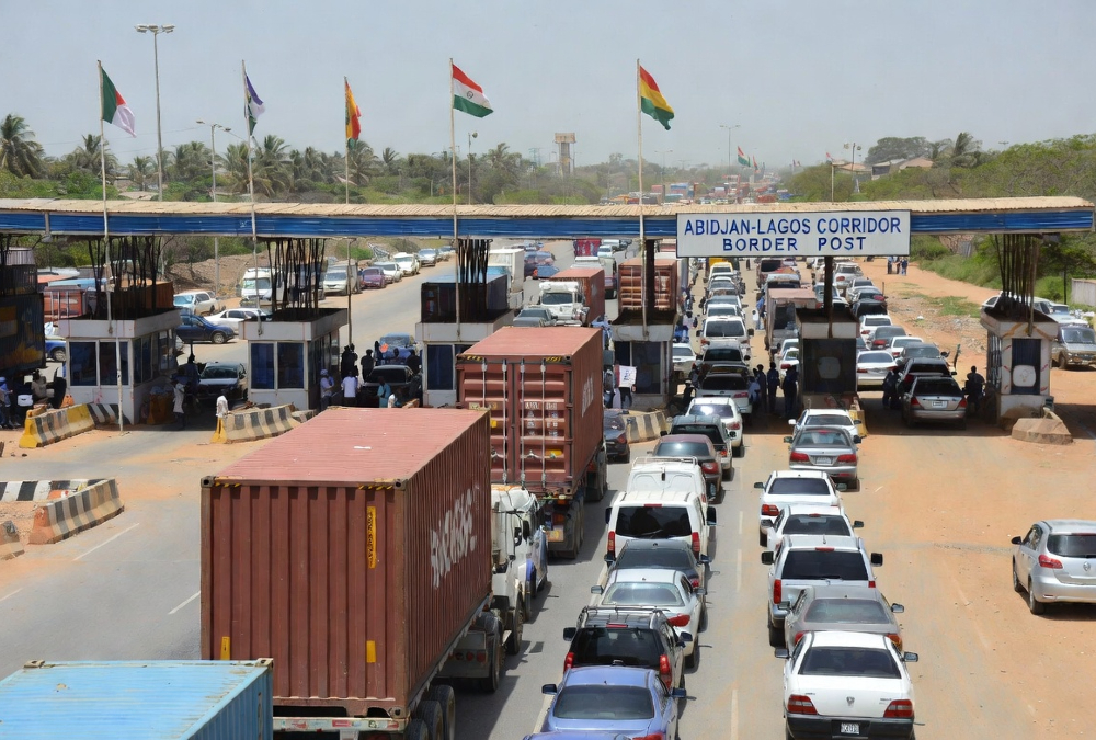 Vehicles on the Abidjan-Lagos corridor waiting at a border checkpoint, illustrating Africa corridor governance challenges and the need for shared ownership and logistics performance metrics.