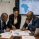 African Business professionals reviewing market entry strategy documents for African industrial markets