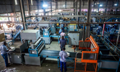 Uganda factory workers processing raw materials into finished goods