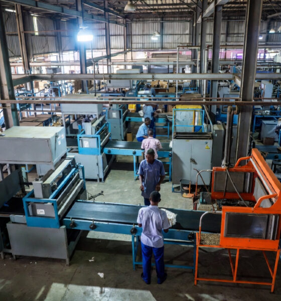 Uganda factory workers processing raw materials into finished goods