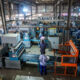 Uganda factory workers processing raw materials into finished goods