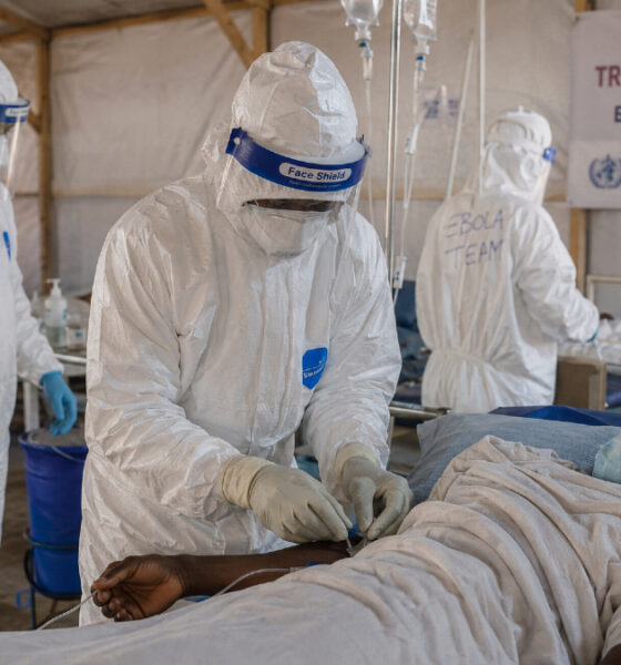 Health workers in hazmat suits treating Ebola patients at a medical facility in the Democratic Republic of Congo during the 2026 outbreak.