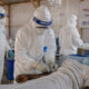 Health workers in hazmat suits treating Ebola patients at a medical facility in the Democratic Republic of Congo during the 2026 outbreak.