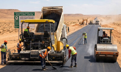 Construction workers paving the Trans-Saharan Highway (TAH 2) linking Algiers to Lagos, part of Africa's infrastructure development initiative