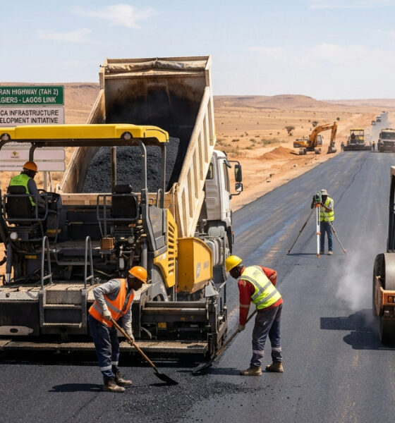 Construction workers paving the Trans-Saharan Highway (TAH 2) linking Algiers to Lagos, part of Africa's infrastructure development initiative