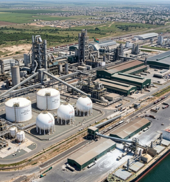 Aerial view of a large modern fertilizer plant complex in Africa with natural gas storage tanks and shipping port, symbolizing the continent's shift from fertilizer import dependency to domestic manufacturing for food security and industrial growth.