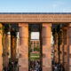 Stone pillars representing robust democratic institutions in Africa supporting sustainable state capacity and governance.