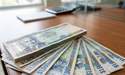 Jamaican dollar bills representing the new J$17,000 weekly minimum wage in Jamaica