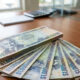 Jamaican dollar bills representing the new J$17,000 weekly minimum wage in Jamaica