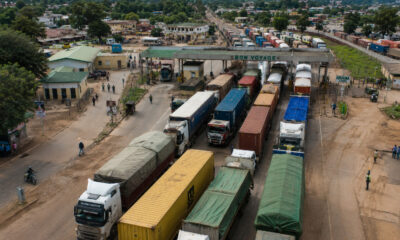 Aerial view of a busy African border crossing with trucks queued for customs clearance, illustrating the trade facilitation challenges facing intra-African commerce.