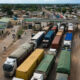 Aerial view of a busy African border crossing with trucks queued for customs clearance, illustrating the trade facilitation challenges facing intra-African commerce.