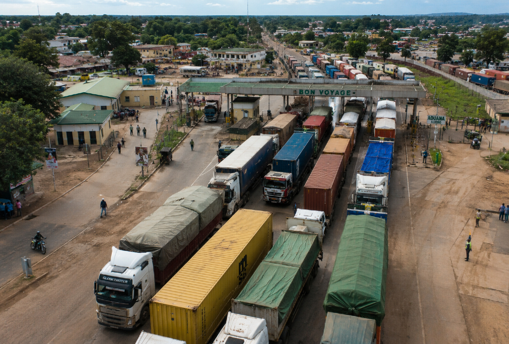 Aerial view of a busy African border crossing with trucks queued for customs clearance, illustrating the trade facilitation challenges facing intra-African commerce.