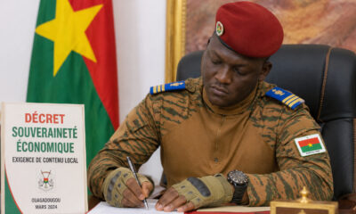 Captain Ibrahim Traoré signing economic sovereignty decree in Ouagadougou, reinforcing local content requirements