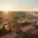 Heavy machinery and construction equipment at work on a large-scale infrastructure project in sub-Saharan Africa.