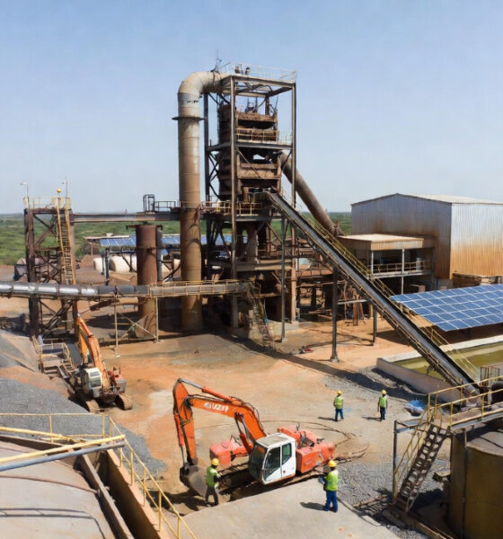 African mineral processing plant with workers and heavy machinery, highlighting the need for sustainable industrialization and reliable infrastructure across the continent.