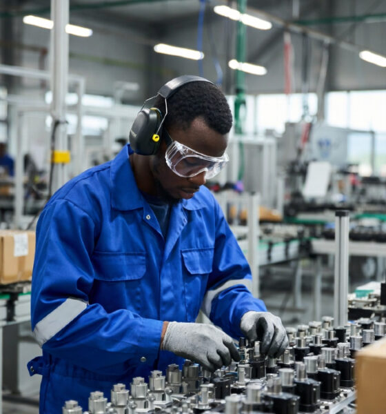 African industrial worker assembling components in a modern factory as part of regional supply chain development under the AfCFTA.