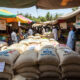 Burkina Faso rice sacks in a West African market, highlighting the impact of the rice import ban on regional trade and food sovereignty.