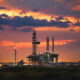 African oil rig and gas infrastructure at sunset, symbolizing Africa's $45 billion energy investment drive across oil, gas, and renewable power projects