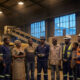 African mine workers and community members standing together near industrial machinery, symbolizing conscious capitalism and equitable economic development in Africa