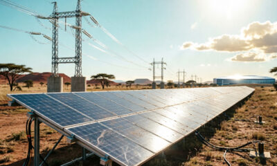 Solar panels and power transmission lines in Africa symbolizing the energy infrastructure needed to power the continent's AI future