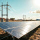 Solar panels and power transmission lines in Africa symbolizing the energy infrastructure needed to power the continent's AI future