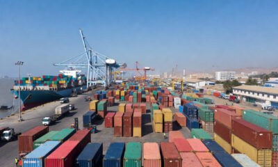 Shipping containers at an African port, representing the paradox where moving goods between neighboring African countries costs more than shipping from China.