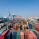 Shipping containers at an African port, representing the paradox where moving goods between neighboring African countries costs more than shipping from China.