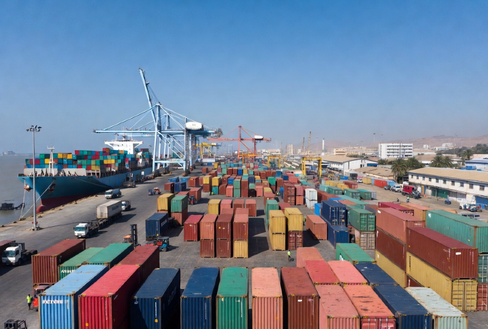Shipping containers at an African port, representing the paradox where moving goods between neighboring African countries costs more than shipping from China.