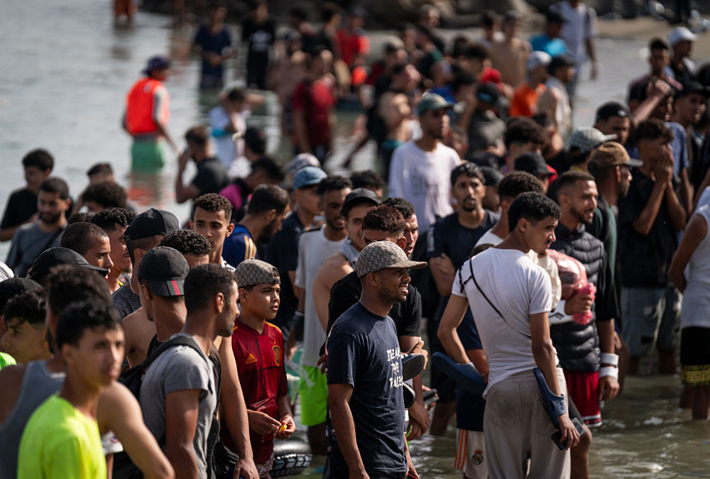 Migrants crossing the sea border into Ceuta, Spain during the 2026 migration crisis from Morocco