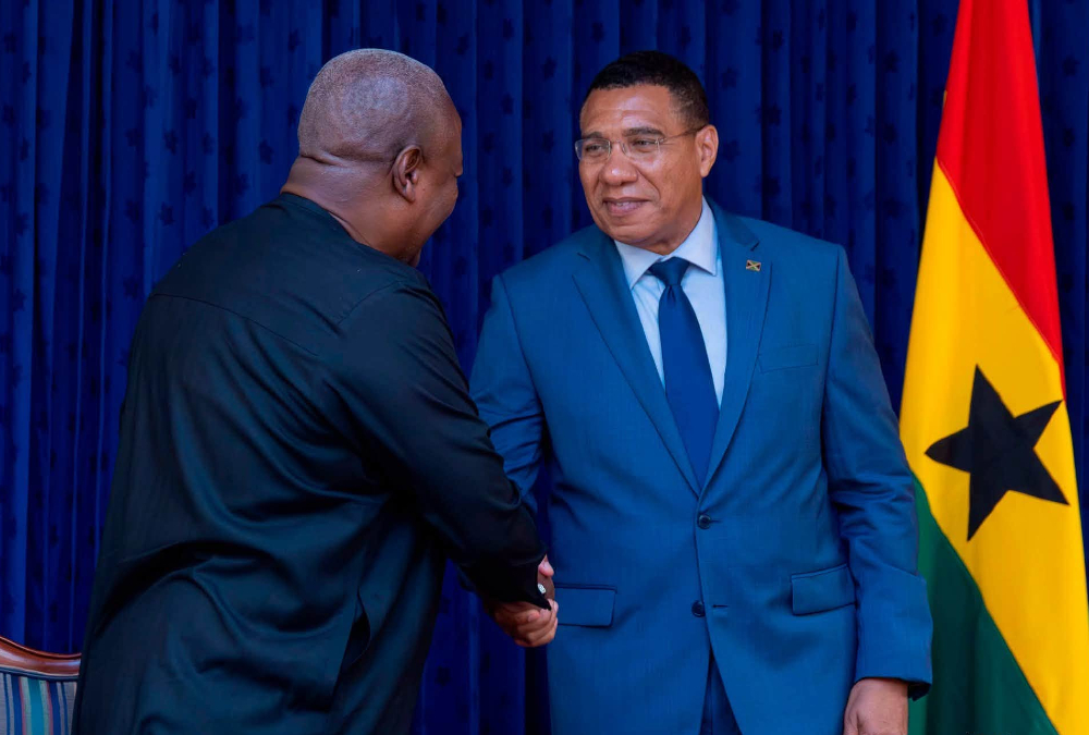 Ghanaian President John Mahama and Jamaican Prime Minister Andrew Holness shake hands during state visit, announcing Africa-Caribbean free trade proposal and direct Accra-Montego Bay flights.