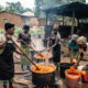 Women palm oil processors working in informal sector, extracting and packaging red palm oil in rural Nigeria, backbone of continent's women-led agricultural value chain.
