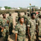 African soldiers in formation during a military review, representing the continent's frequent command reshuffles and the tension between professionalism and presidential loyalty
