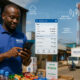 African distributor running a business from a smartphone as a cell tower delivers fiber-fed mobile broadband