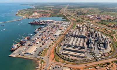 Aerial view of an African port and factory complex linked by regional trade routes.