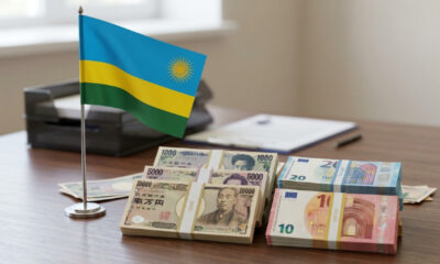 Rwandan flag beside Japanese yen and euro banknotes, symbolizing Rwanda's multi-currency loan
