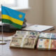Rwandan flag beside Japanese yen and euro banknotes, symbolizing Rwanda's multi-currency loan